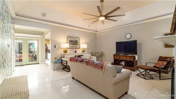 a living room with furniture a flat screen tv and a window