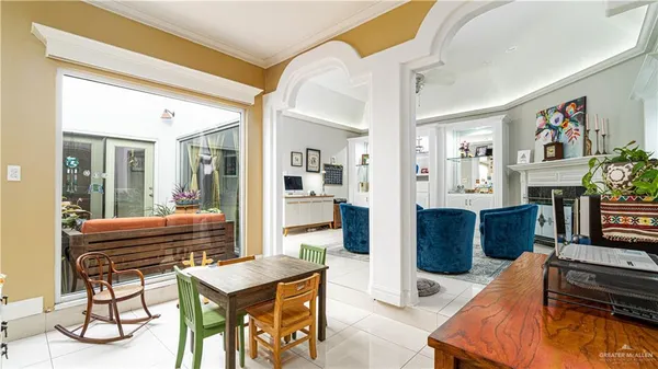 a living room with furniture and a dining table