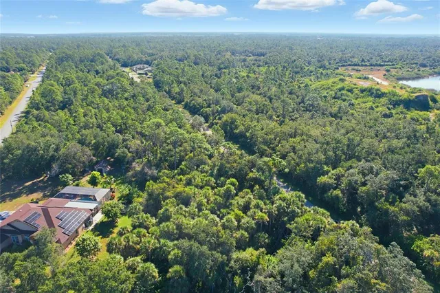 an aerial view of a houses with a yard