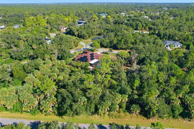 an aerial view of a houses with yard