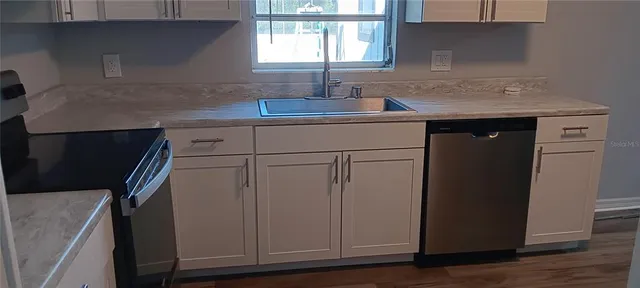 a kitchen with a sink and cabinets