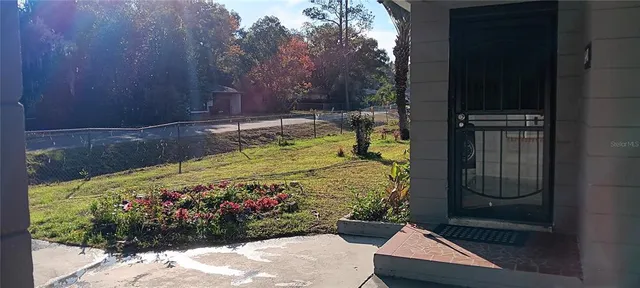 a bed sitting in a bedroom next to a yard
