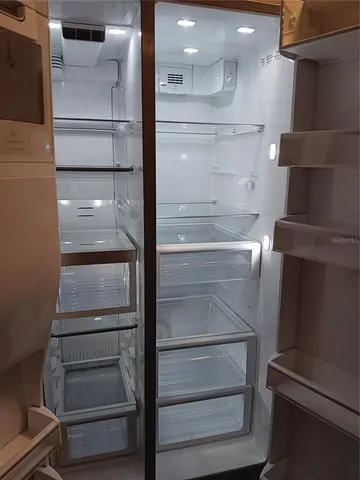 a view of walk in closet with empty racks
