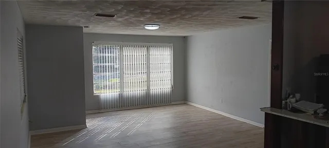 a view of an empty room with a window