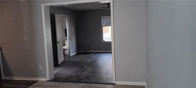 a view of a hallway with wooden floor