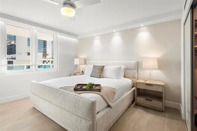 a bedroom with bed and a night stand