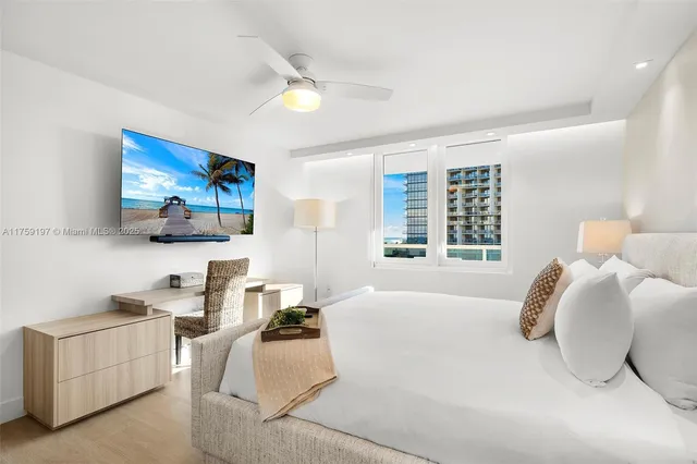 a bedroom with furniture and a large window