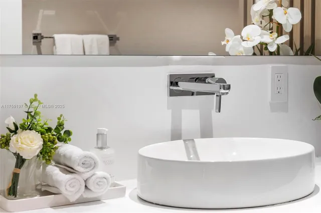 a bedroom with a bed mirror and window