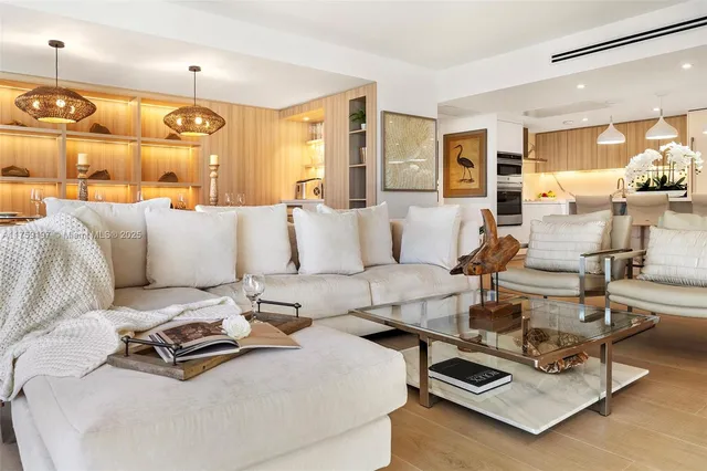 a living room with furniture gym equipment and a view of kitchen