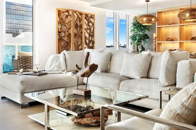 a living room with furniture and a chandelier