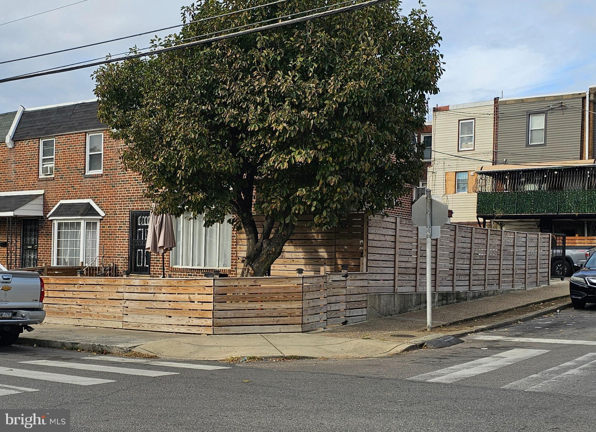 a yellow house with trees in front of it