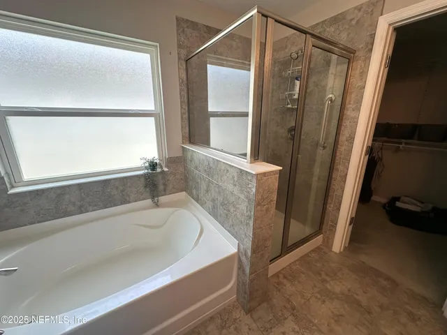 a bathroom with a bathtub and a shower