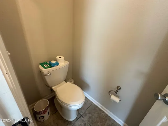 a white toilet sitting next to a bathroom sink
