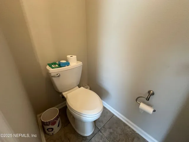 a white toilet sitting next to a sink