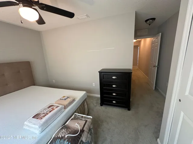 a bedroom with a bed and a mirror