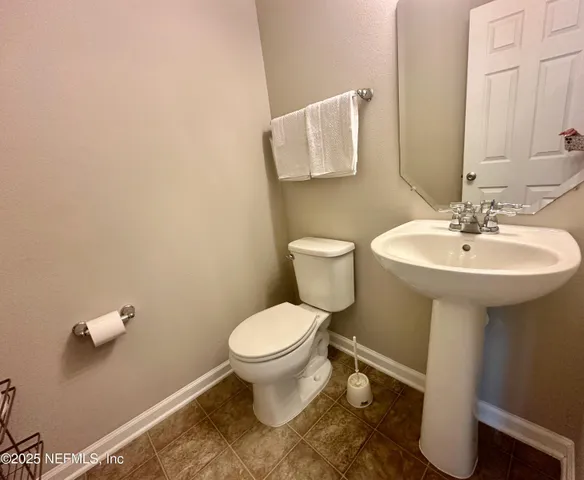 a bathroom with a sink toilet and a mirror