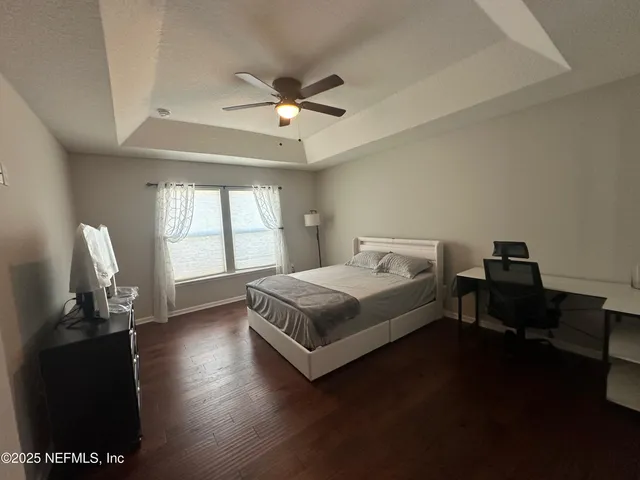 a spacious bedroom with a bed and a window