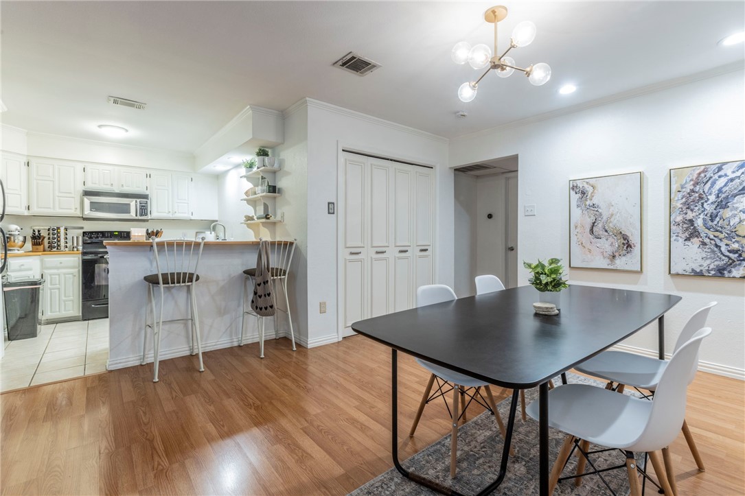 2307 Melissa Drive Waco, TX 76708 - Photo 12 of 23 a kitchen with kitchen island a dining table chairs cabinets and stainless steel appliances