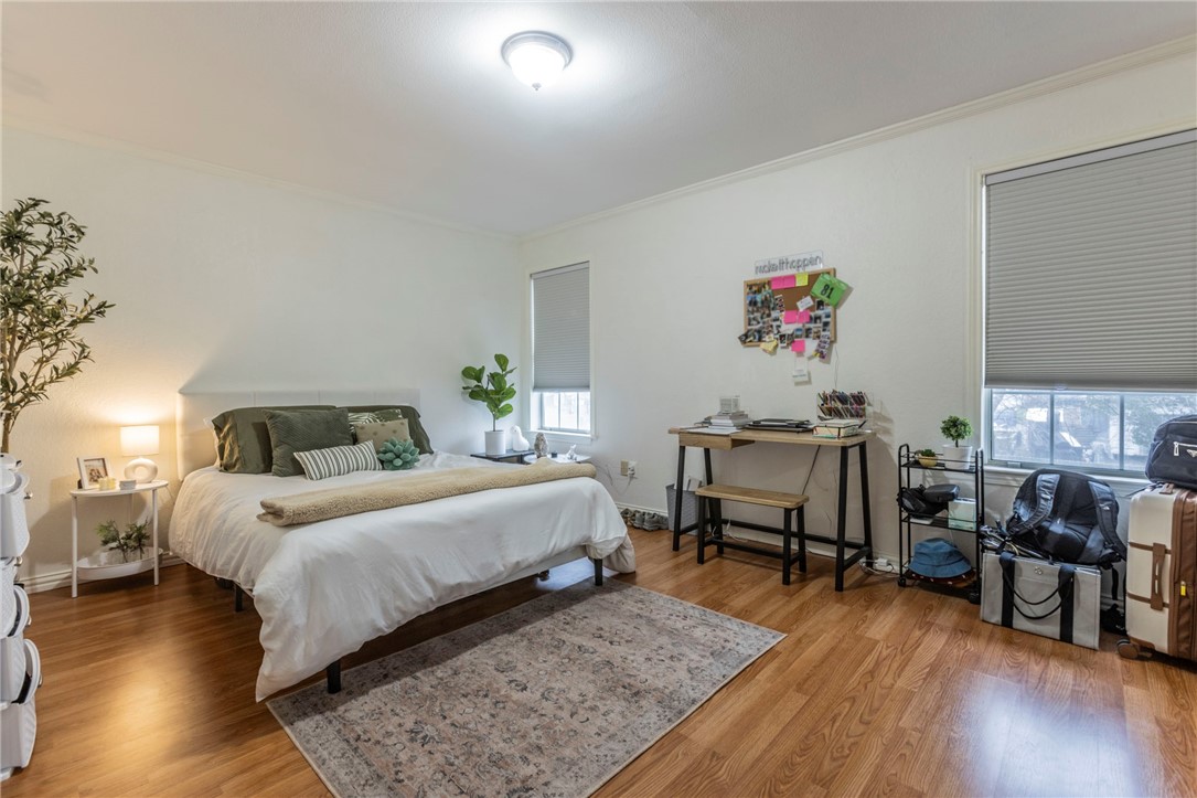 2307 Melissa Drive Waco, TX 76708 - Photo 13 of 23 a bedroom with a bed and wooden floor