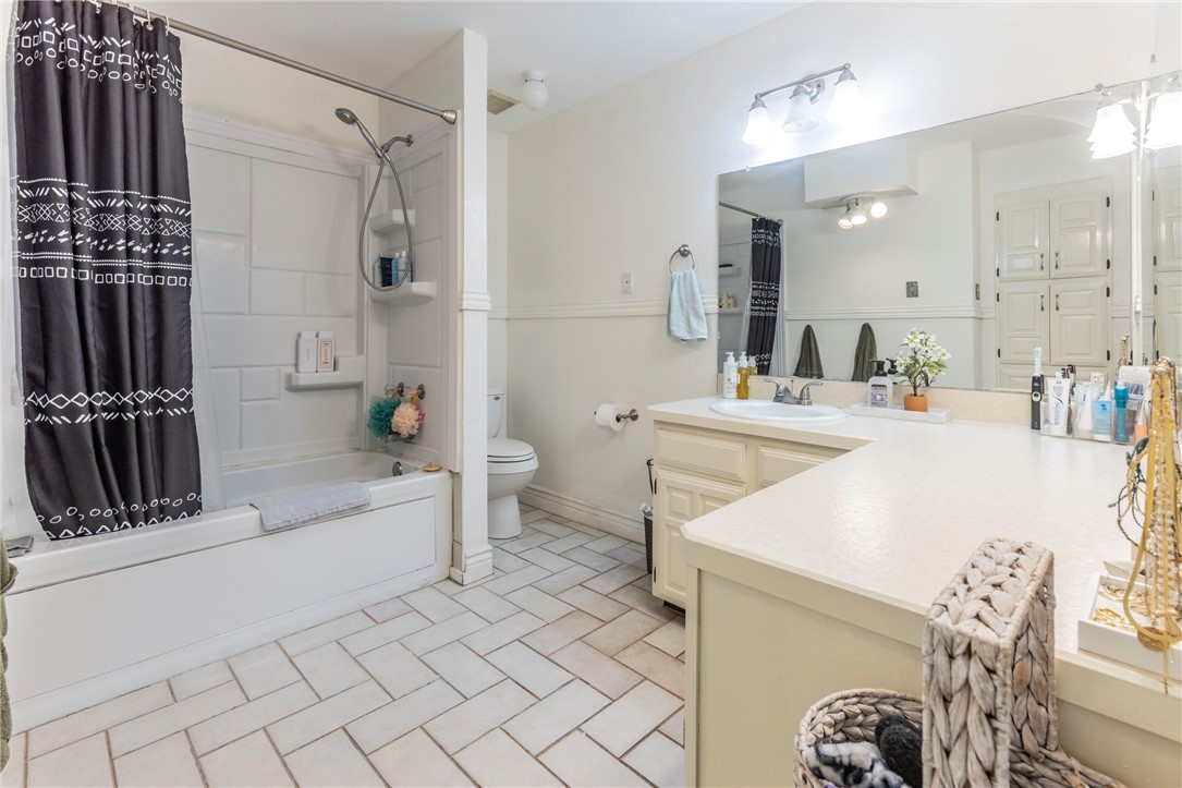 2307 Melissa Drive Waco, TX 76708 - Photo 16 of 23 a bathroom with a sink vanity granite toilet tub and shower