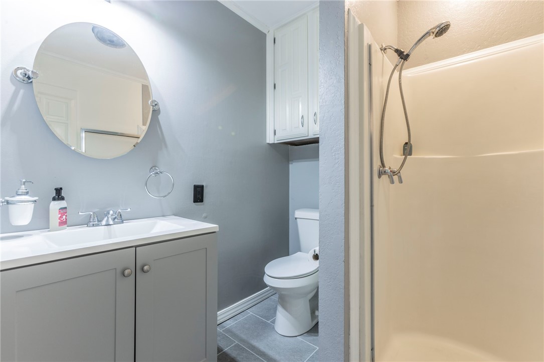 2307 Melissa Drive Waco, TX 76708 - Photo 21 of 23 a bathroom with a toilet sink vanity and mirror