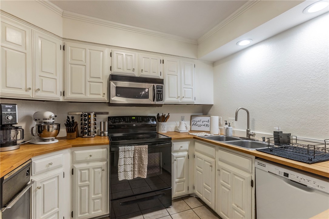 2307 Melissa Drive Waco, TX 76708 - Photo 6 of 23 a kitchen with stainless steel appliances granite countertop a stove a sink dishwasher and a microwave