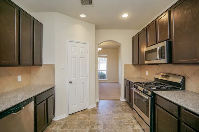 a kitchen with a sink cabinets and window