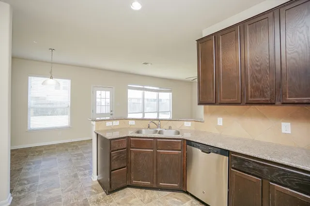 a kitchen with stainless steel appliances granite countertop stove top oven and microwave