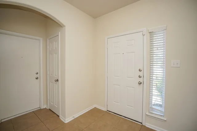 an empty room with windows and entrance
