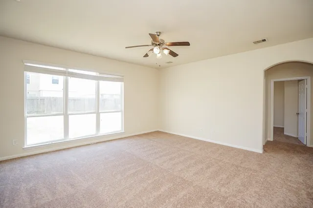 an empty room with a empty space and a ceiling fan