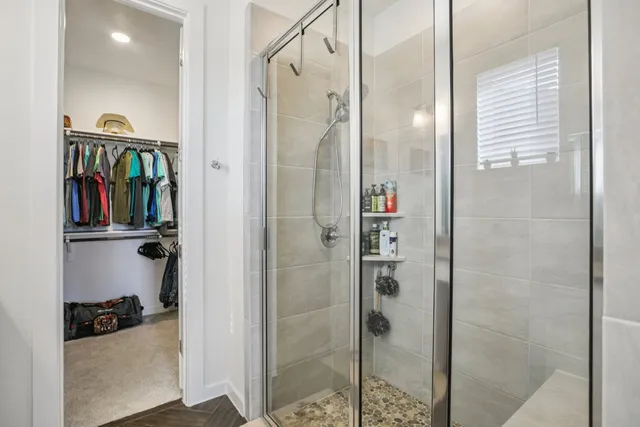 a bathroom with a shower and a glass door