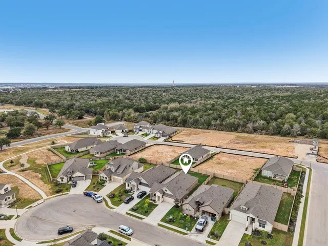 an aerial view of residential houses with outdoor space
