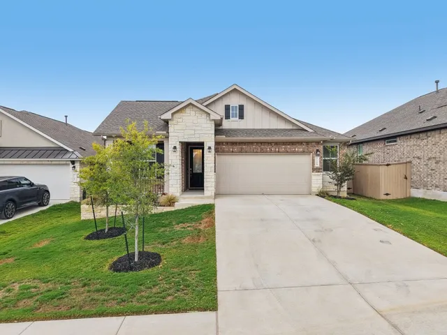 a front view of house with a garden