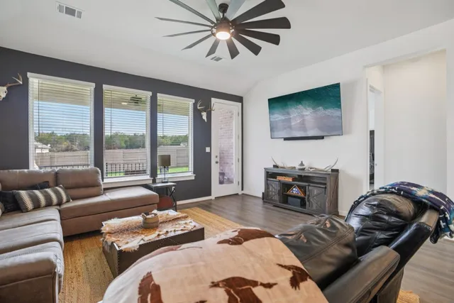a bedroom with furniture and a flat screen tv