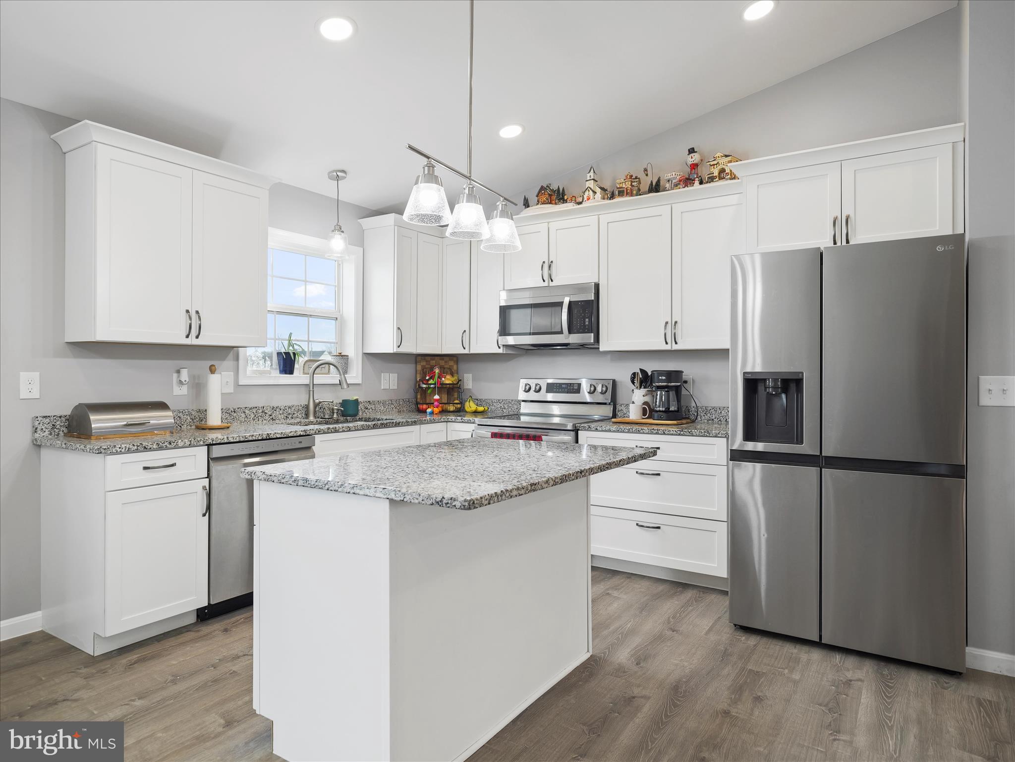 1885 Giles Mill Road Inwood, WV 25428 - Photo 18 of 40 a kitchen with stainless steel appliances granite countertop a refrigerator a sink dishwasher a stove and white cabinets with wooden floor