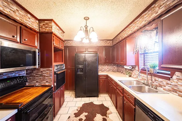a view of a house with a yard covered in snow