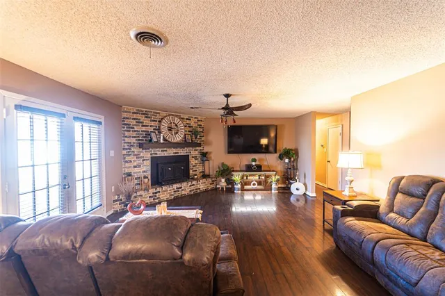 a view of a house with a large tree and a yard