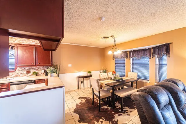 a view of a house with a yard and wooden fence