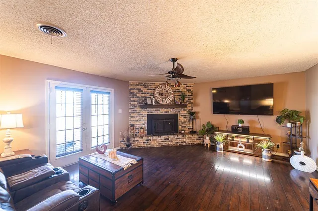 a view of a yard with a house and a large tree