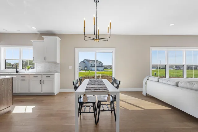a living room with furniture a window and a kitchen view