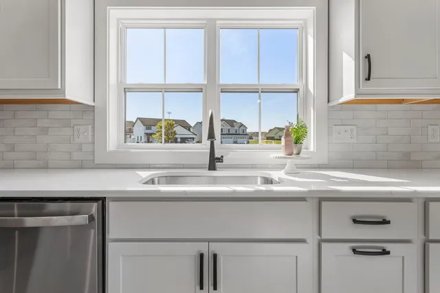 a kitchen with a sink and a window
