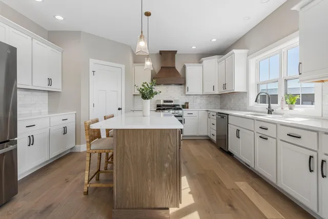 a kitchen with a sink window and cabinets