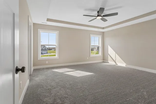 a view of a livingroom with a ceiling fan and window