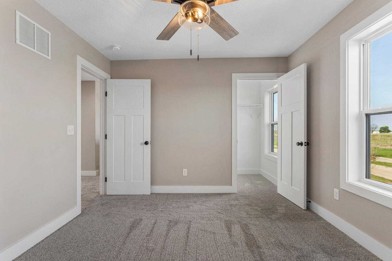 500 Prairie Meadows Drive Heyworth, IL 61745 - Photo 29 of 45 a view of an empty room with window and wooden floor