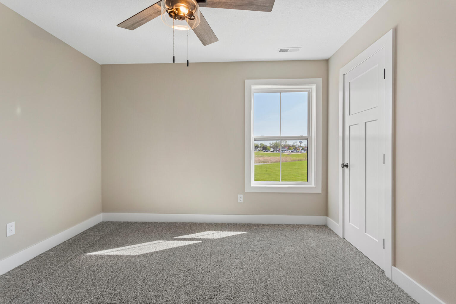 500 Prairie Meadows Drive Heyworth, IL 61745 - Photo 33 of 45 an empty room with a window and a ceiling fan