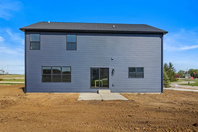 a view of a house with a yard and storage space