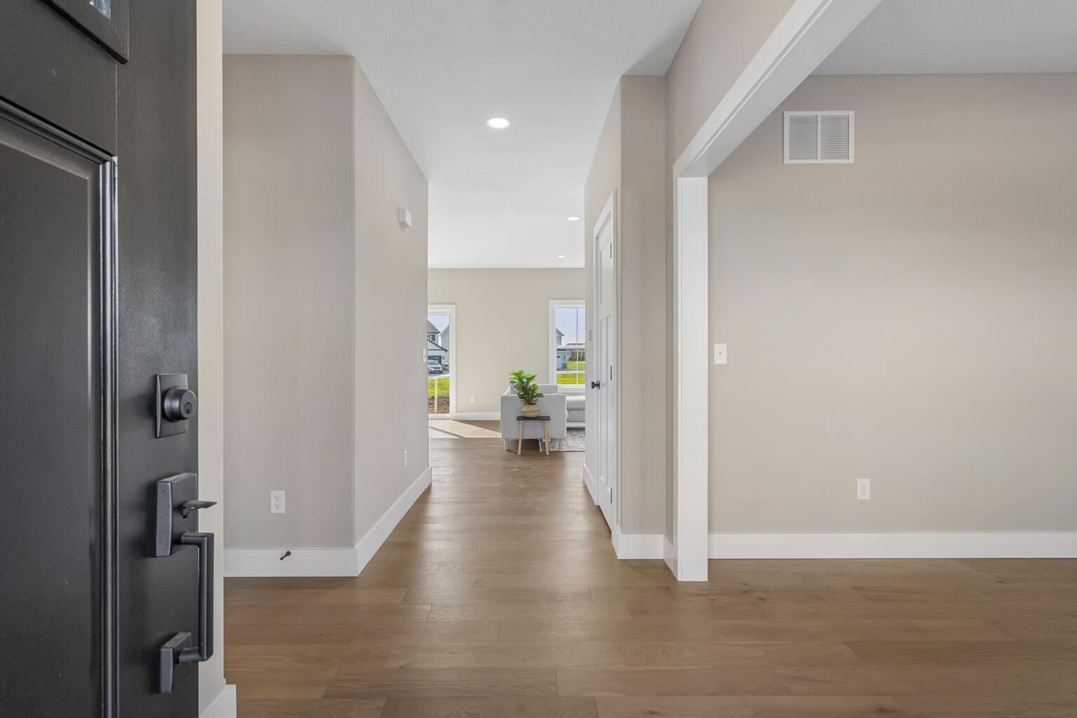 500 Prairie Meadows Drive Heyworth, IL 61745 - Photo 5 of 45 a view of a hallway with wooden floor and a living room