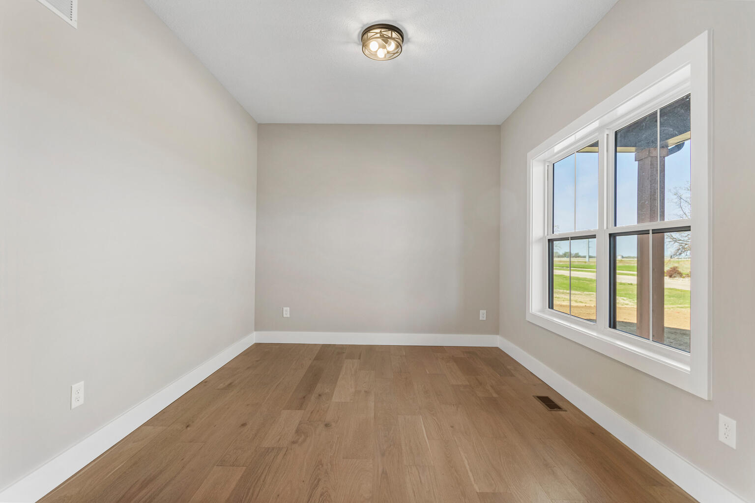 500 Prairie Meadows Drive Heyworth, IL 61745 - Photo 6 of 45 an empty room with wooden floor and windows