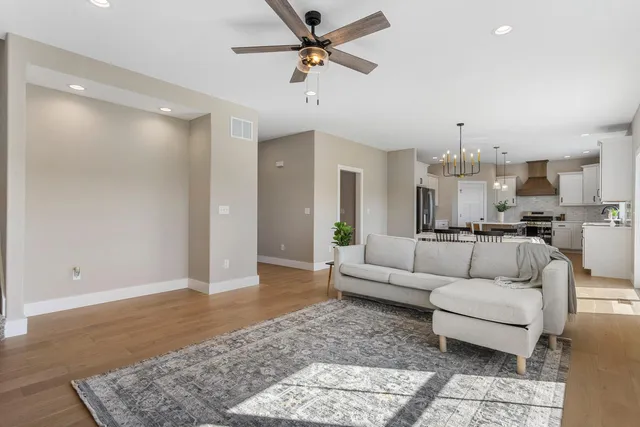 a living room with furniture and a chandelier