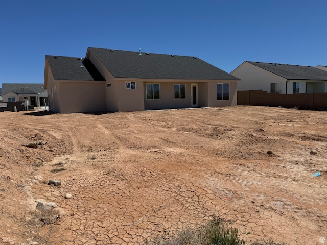 5005 North 75 East Enoch, UT 84721 - Photo 23 of 37 Rear view of house featuring stucco siding and a residential view